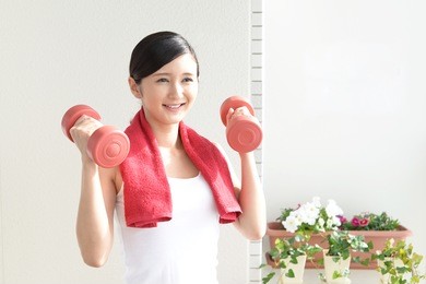 beautiful slim woman with dumbbells