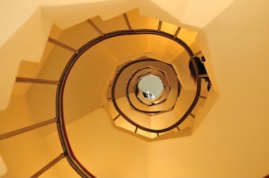 wide-angle view down a spiral stairs of the lighthouse