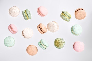 colorful macarons cake, top view flat lay, fly falling sweet macaroon on color white isolated background. minimal concepts falling macaroons pattern above, food natural background