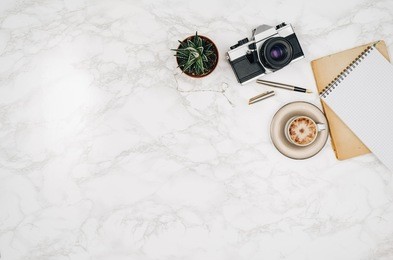 accessories for travel top view on white marble table background with copy space. adventure and wanderlust concept image with travel accessories. preparing for an exotic trip, journey and sightseeing.