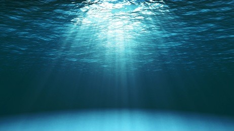 dark blue ocean surface seen from underwater. abstract waves underwater and rays of sunlight shining through. 3d illustration