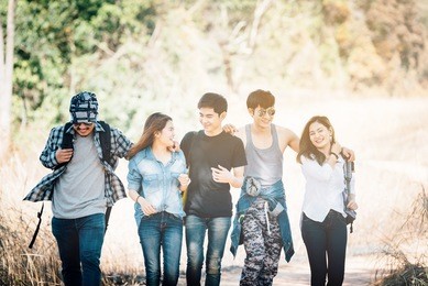 asian traveler with friends, group backpacks young walking together and looking happy