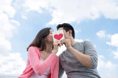 happy couple hugging together and laughing at camera