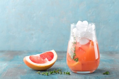 grapefruit and thyme gin cocktail, refreshing drink with ice