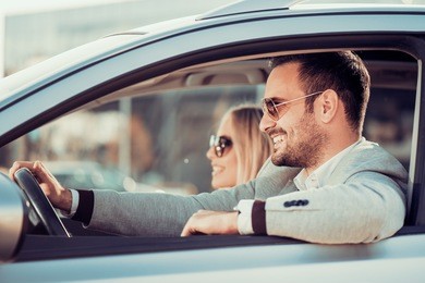 happy couple driving in car.road trip,travel, love and people concept.