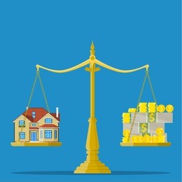 scales with house and money. real estate, rental, expense, liabilities and mortgage concept