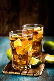 cuba libre or long island iced tea cocktail with strong drinks, cola, lime and ice in glass, cold longdrink or lemonade
