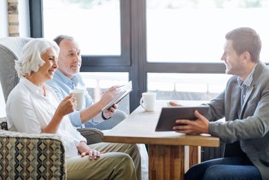 nice smiling aged couple having meeting in the cafe