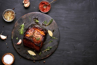 bbq meat, grilled pork on dark background with copy space.