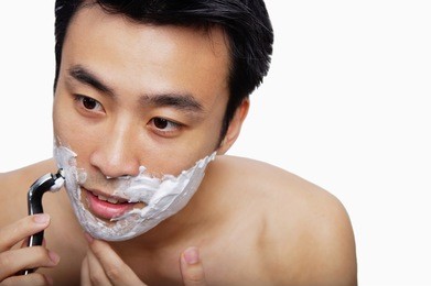 man holding shaver to face, shaving