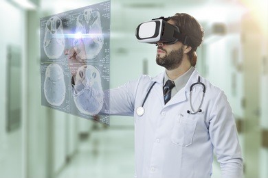 male doctor at a hospital, using a virtual reality glasses, looking at a virtual screen.