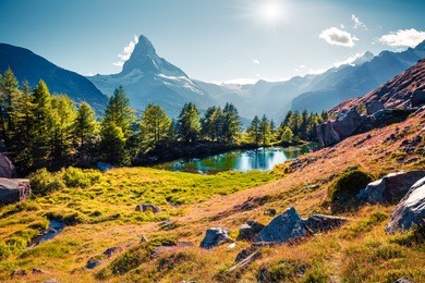colorful summer sunrise on the grindjisee lake. reflection of matterhorn (monte cervino, mont cervin) peak in the watter surface. beautiful outdoor scene in swiss alps, zermatt location, switzerland.