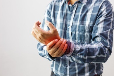 man suffering from elbow joint pain people /  healthcare and problem concept