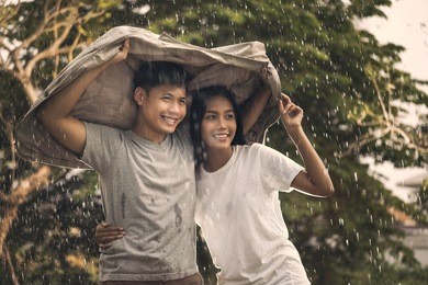 asian couple romantic time in the rain