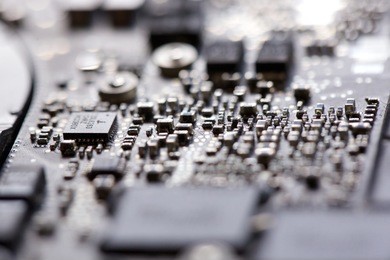 soft window light macro closeup of intricate silicon circuit motherboard at oblique angle with shallow depth of field of miniature transistors and resistors like a tiny futuristic city 