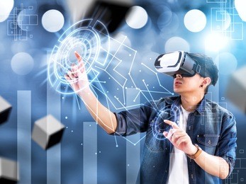 visual reality concept.young asian man using visual reality or vr headset and interacting with object.man getting experience using vr-headset glasses.