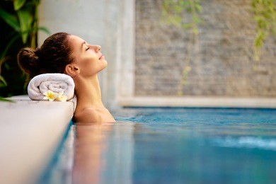 beauty and body care. sensual young woman relaxing in outdoor spa swimming pool.