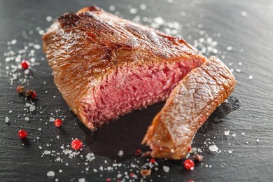 grilled steak with rosemary on a  wooden background