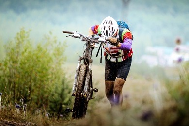 athlete cyclist mountainbiker going uphill with my bike