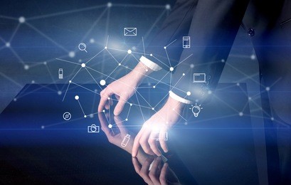 male hands touching interactive table with blue mixed communication icons in the background
