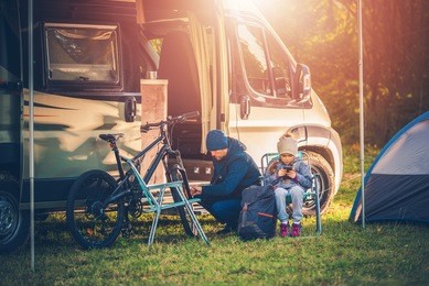family vacation with motorhome. family on the campsite. recreation and fun concept.