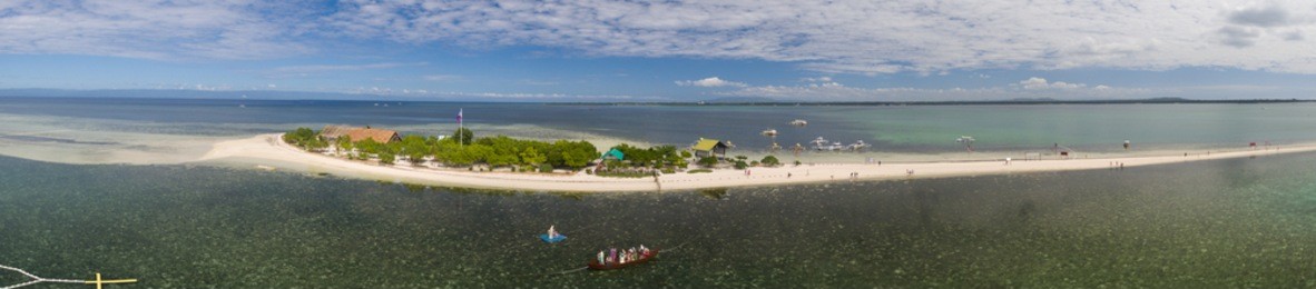 a wide panorama of the entire virgin island located near panglao, bohol, philippines featuring the mama mary in the ocean.