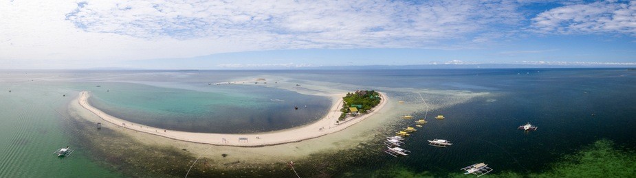 a wide panorama of the entire virgin island located near panglao, bohol, philippines featuring the boats landing area.