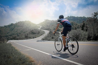 man cycling mountain road bike in the morning