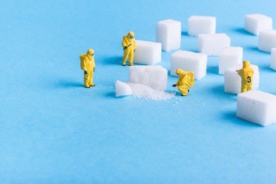 the team investigates the sugar cubes on a blue background