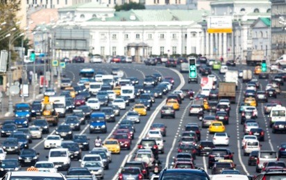lanes of a wide city street with lots of cars