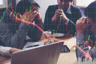 team businessman with chart in the fall. economy or stock market going down.