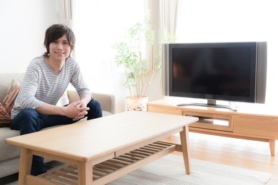 young asian man watching tv in  the living room