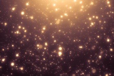 golden abstract sparkles or glitter lights. festive gold background. defocused circles bokeh or particles. template for design.