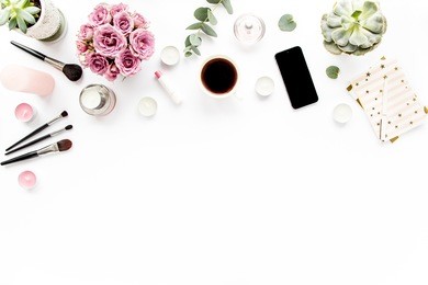 office table desk. flat composition, magazines, social media. top view. flat lay. home office workspace. women's fashion. bouquet of roses, eucalyptus, coffee on white background.