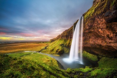 seljalandsfoss waterfall  in iceland at sunset. long exposure.