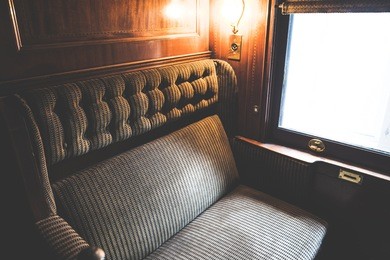 vintage tone photography of bench seat in the train with window