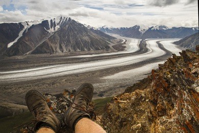 overseeing a kaskawulsh glacier from observation mountain from perspective of first person. pov. hiker, hiking shoes, kluane national park, yukon, canada. global warming. north america. alaska. relax.