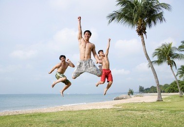 three men jumping in air, looking at camera