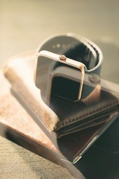 luxury golden smart watches,leather wallet,passport.business accessories for travel.stay always connected.place mobile application on screen