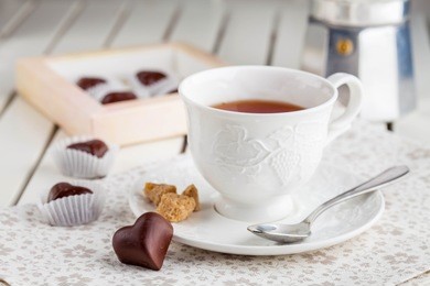 tea in a white cup with chocolate candies