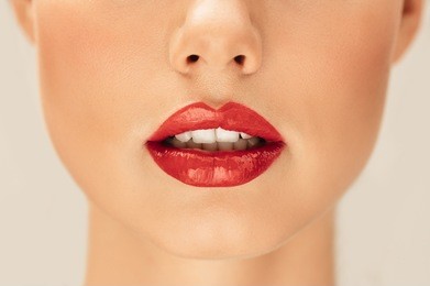close up portrait of woman with red lipstick. cropped shot of beautiful lips of a young woman.
