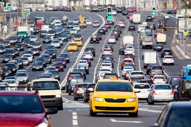 yellow taxi car on the city highway during the rush hour