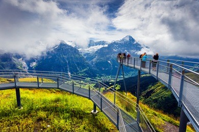 unbelievable summer scene from the extreme view point on the top of grindelwald first cableway. schreckhorn mountain in the morning mist, swiss bernese alps, switzerland, europe.