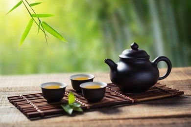 tea cup and teapot on wood plank outside the door