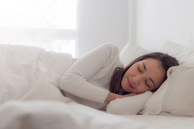 happy asian young beauty women sleeping and smile on bed in the morning