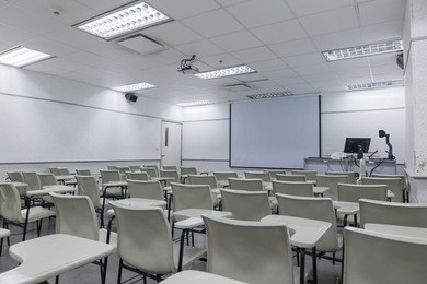 school classroom interior with desk and projector