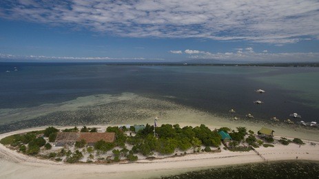 the elusive "virgin island" near bohol, cebu, philippines as seen from an aerial perspective featuring the boat landing area and mainland of the small island.