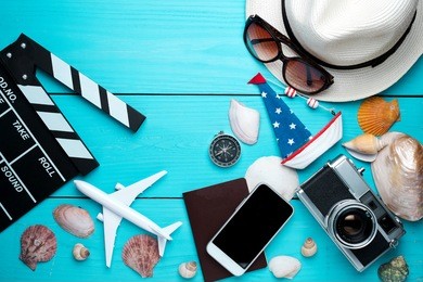 summer holiday background, travel concept with camera on wooden table background, top view