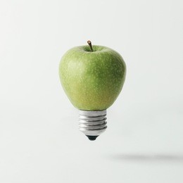 apple lightbulb on bright background. idea concept.
