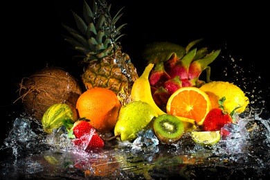 fruits on black background with water splash